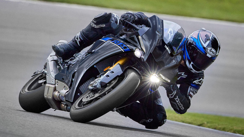 rider leaning on a tight corner with a 2024 Yamaha R1M