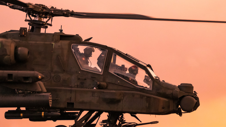 Boeing AH-64 Apache attack helicopter in an evening flight