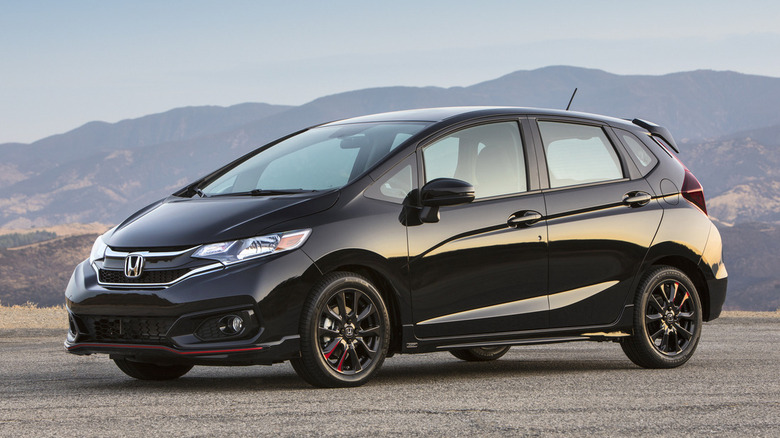 Black 2018 Honda Fit parked against a scenic backdrop