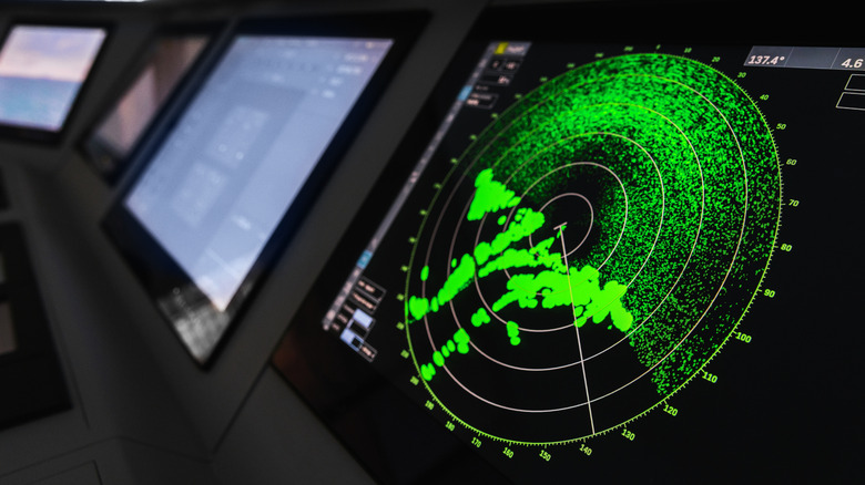Radar screen with green display indication on a captains bridge of modern ship