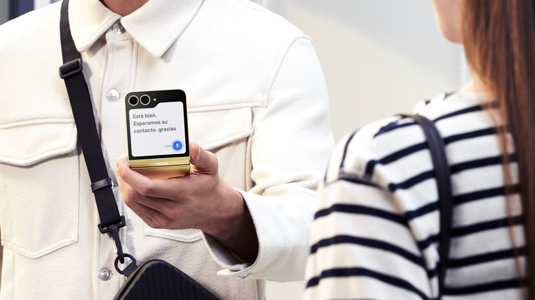 Man holding Galaxy Z Flip with translation