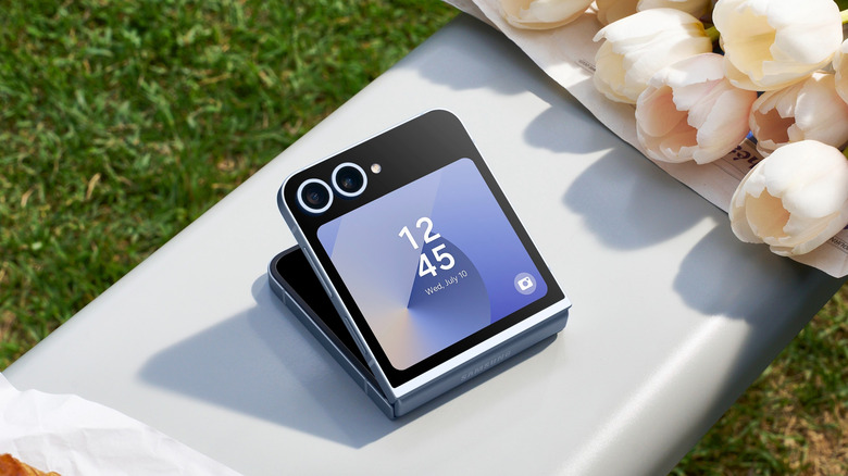 Samsung Galaxy Z Flip partially unfolded on a table outdoors