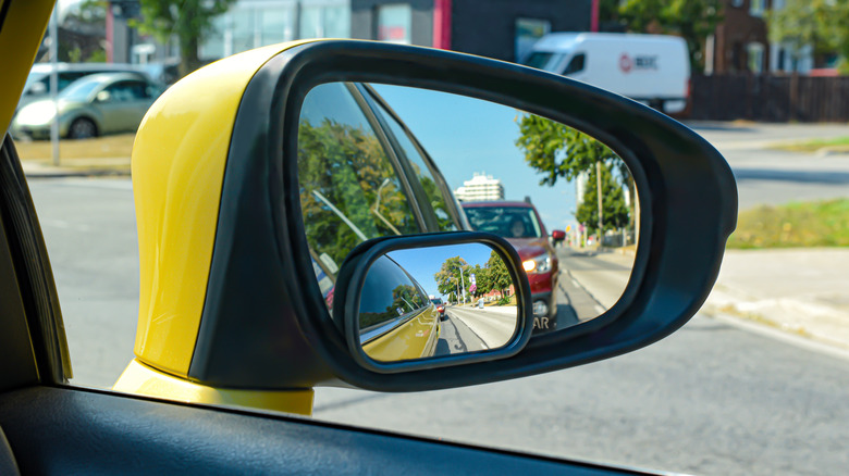 The view from a motor vehicle side mirror through the window