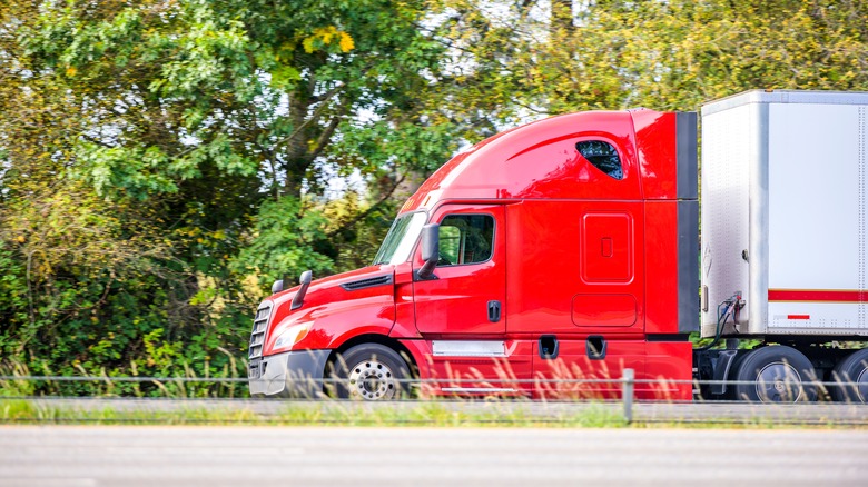 Semi-truck with sleeper cab on highway