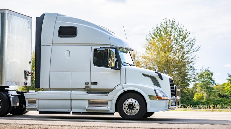 Semi-truck on highway with sleeper cab window