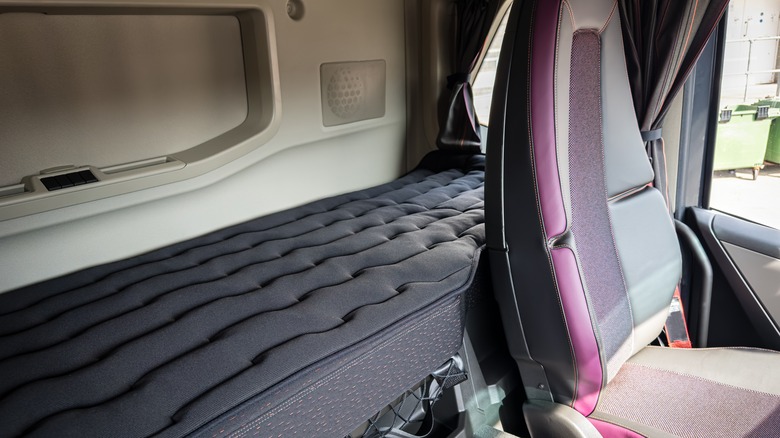 Sleeper cab with bed and curtains