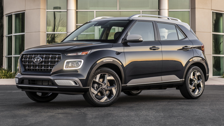 2025 Hyundai Venue parked on a paved surface in front of a building