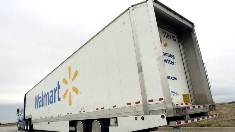 Walmart semi-truck driving on the highway left rear view