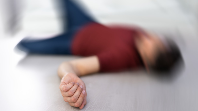 A man experiencing a seizure showcased in the photo by a blur applied implying excessive movement