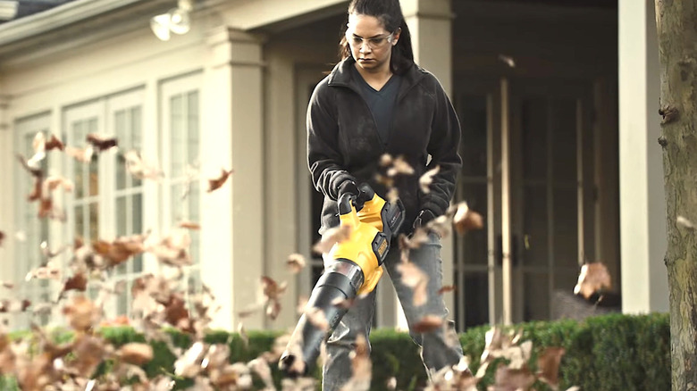 Woman using DeWalt leaf blower