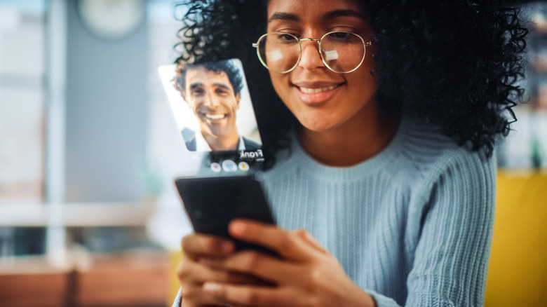 A woman using dating app and checking a man's profile