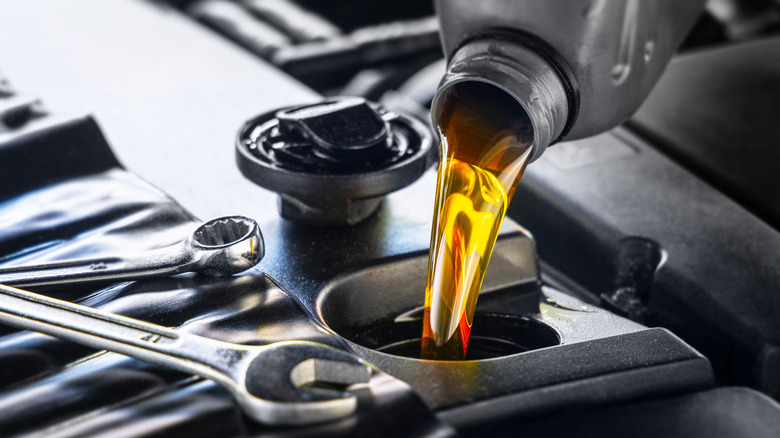 Close-up of motor oil being poured into an engine