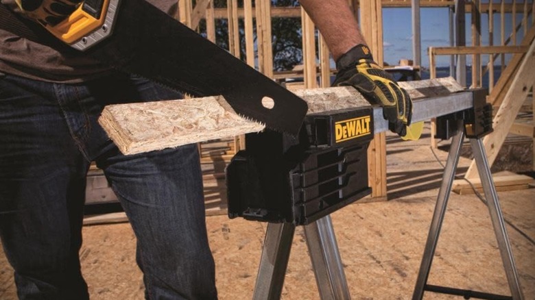 man using DEWALT Folding Workbench