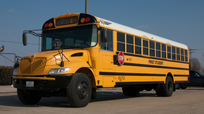 A bright yellow school bus on a street.