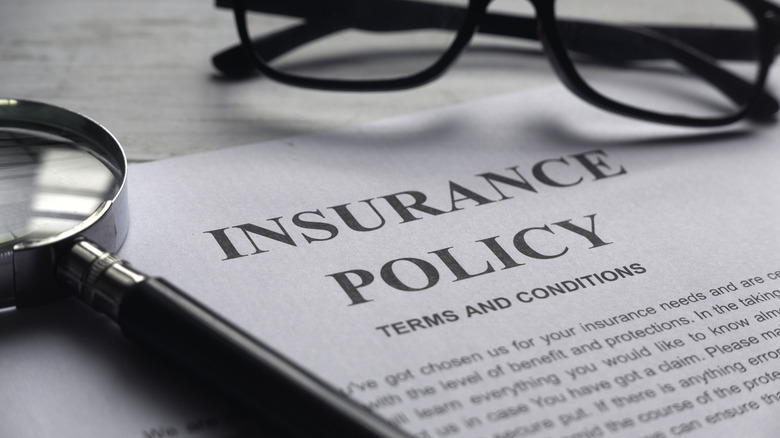 Selective focus on a paper reading out an insurance policy