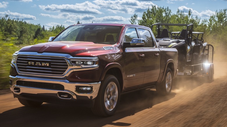 Front view of a 2023 Ram 1500 towing an ATV