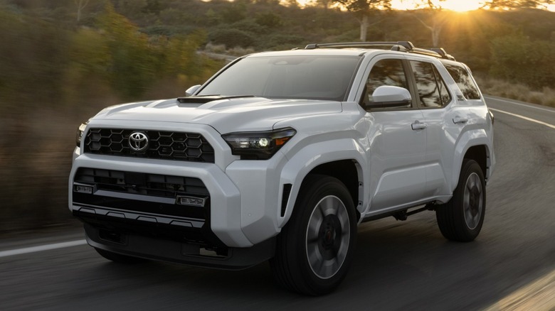 A white Toyota 4Runner TRD Sport cornering on a road