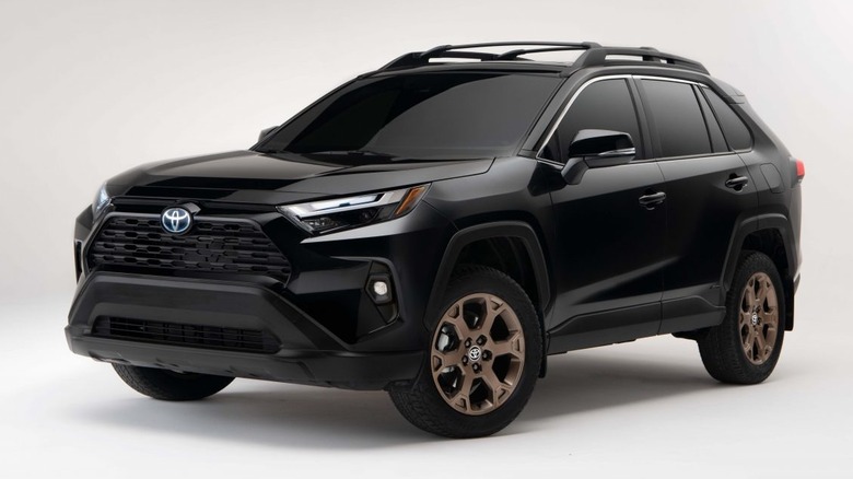 Studio shot of a black 2023 Toyota RAV4 Hybrid Woodland Edition