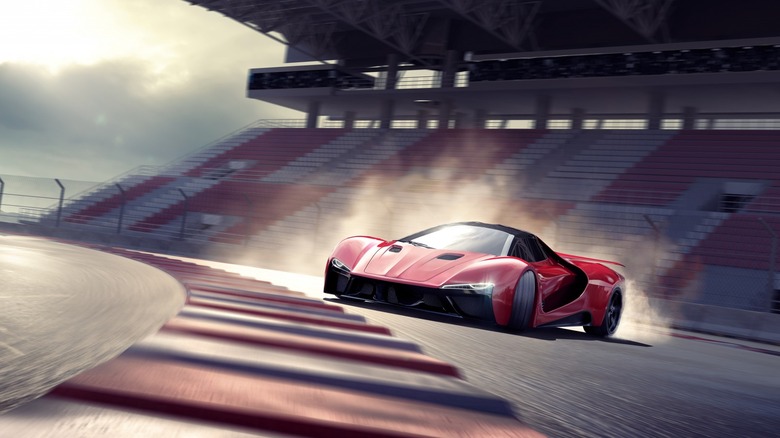 red sports car oversteering on track