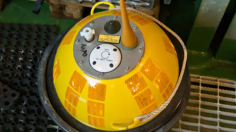 A yellow wave buoy in a container with GPS buttons displayed on top