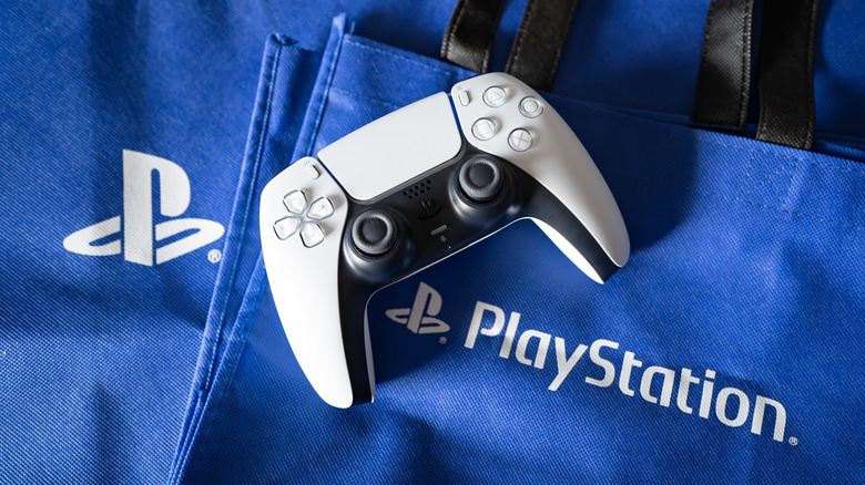 A DualSense controller on a stack of PlayStation bags.