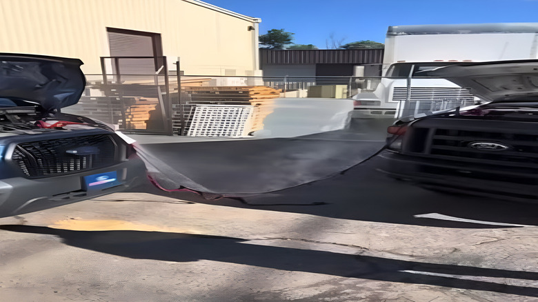 Jumper cable hooked to two cars melting