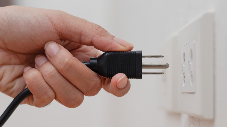 Power supply being plugged in