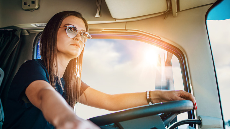 Female truck driver driving a truck