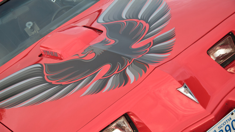 Black hood logo on red Pontiac Firebird