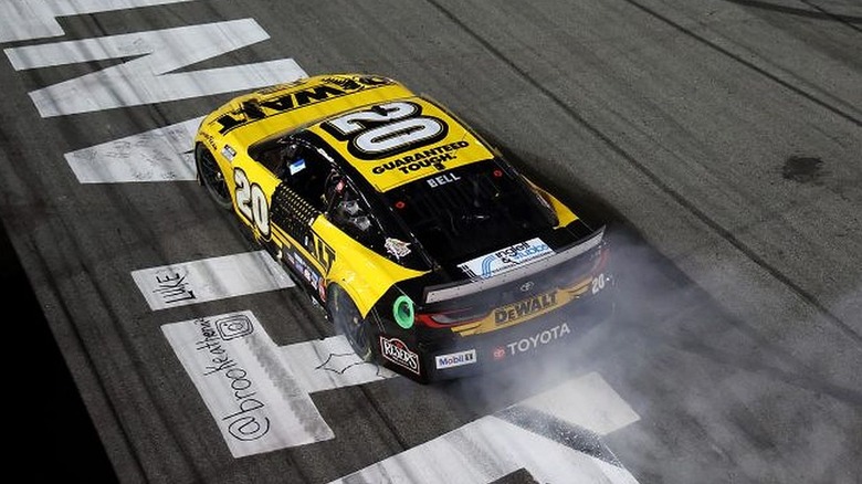 A yellow and black DeWalt Toyota driving on the track