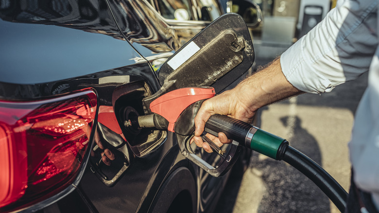 Man refueling his car at a gas station