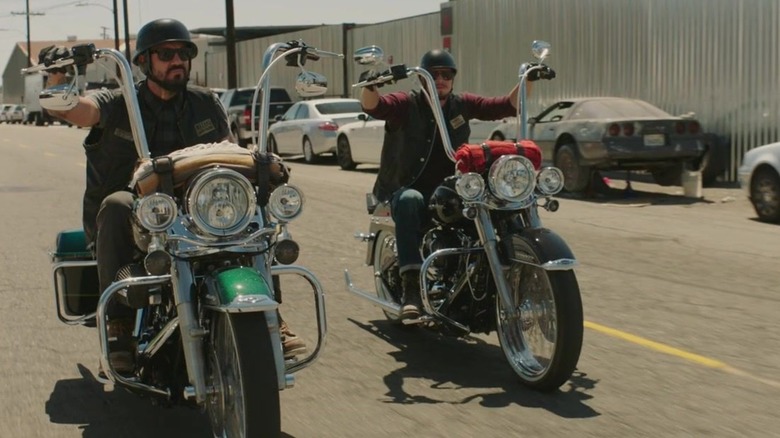 EZ riding a red Harley Davidson motorcycle