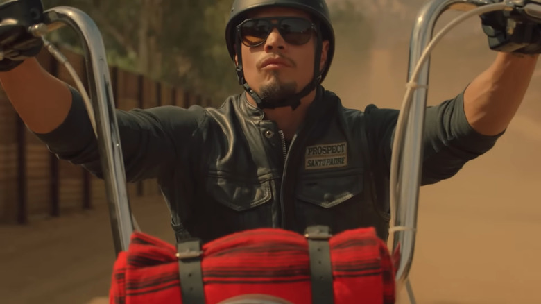 EZ riding his motorcycle with sunglasses and helmet on