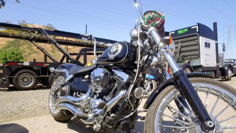 Blue Harley Davidson parked near a railway track