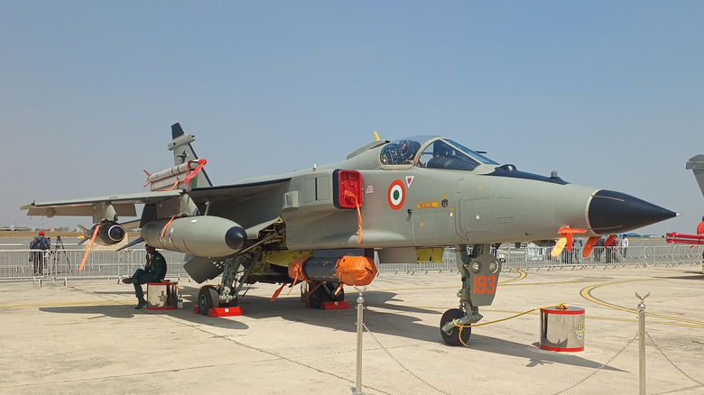 Indian Air Force SEPECAT Jaguar parked on tarmac with weapons attached to hardpoints