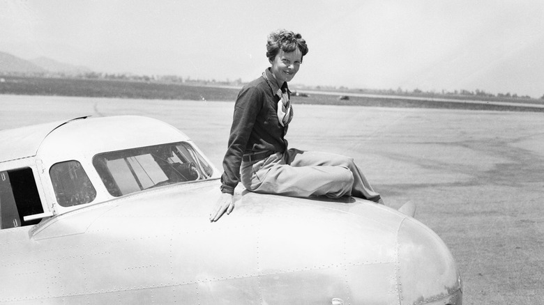 Amelia Earhart sitting on Lockheed Electra