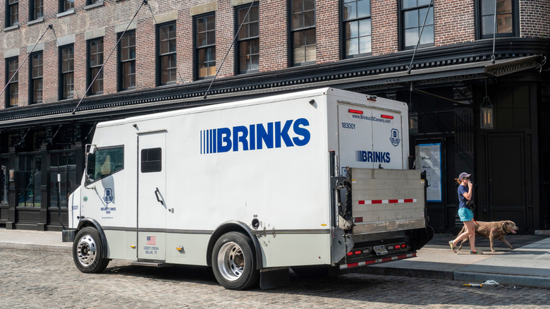 Brinks truck stopped in front of a building