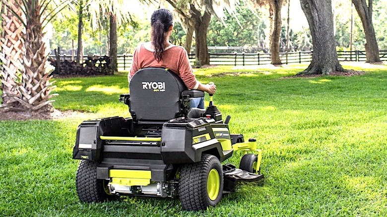 Woman riding Ryobi Zero Turn Mower