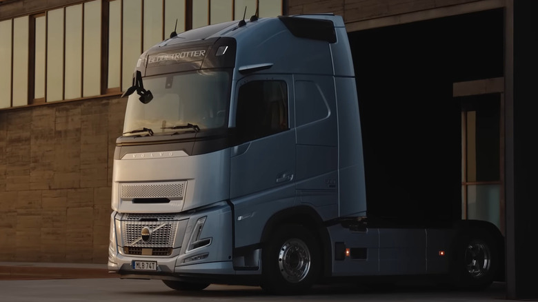 Volvo FH Aero semi-truck in front of a building