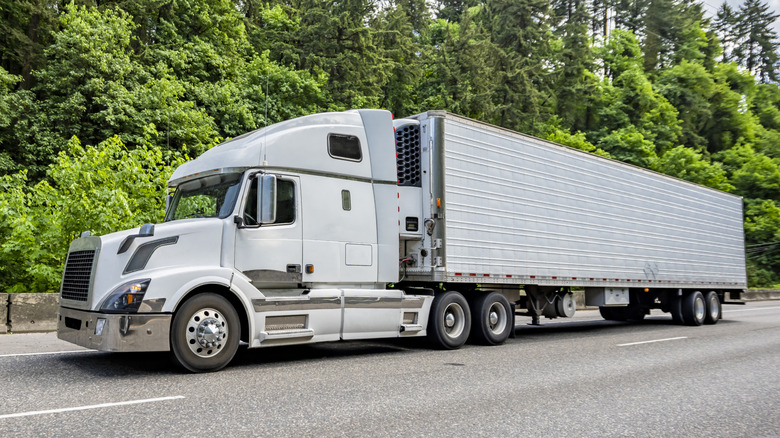 A white semi-truck driving on a highway