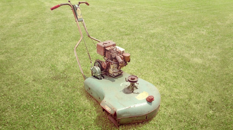 A vintage Snapper Snapping Turtle lawn mower resting on a freshly-cut lawn