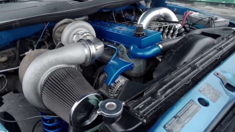 Close up view of a modified 5.9L Cummins on a 1998 Dodge Ram pickup truck