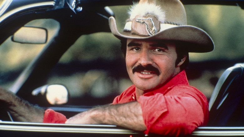 Promotional photo of Burt Reynolds behind the wheel of a Pontiac Trans Am