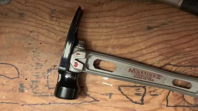 A Martinez Tool Company M1 hammer on a wooden surface.