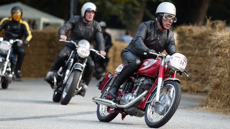 A trio of people racing classic cafe racers