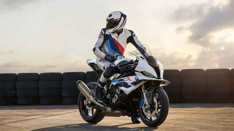 A biker sitting on BMW S 1000 RR and looking back