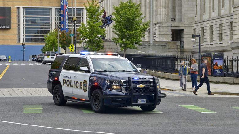 A Chevrolet Tahoe PPV with a MetroTransit Police livery, front 3/4 view, lights on