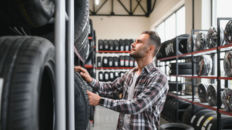 Man picking out tires in a tire shop
