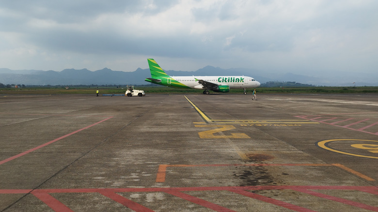 Lone airplane parked on an airport runaway