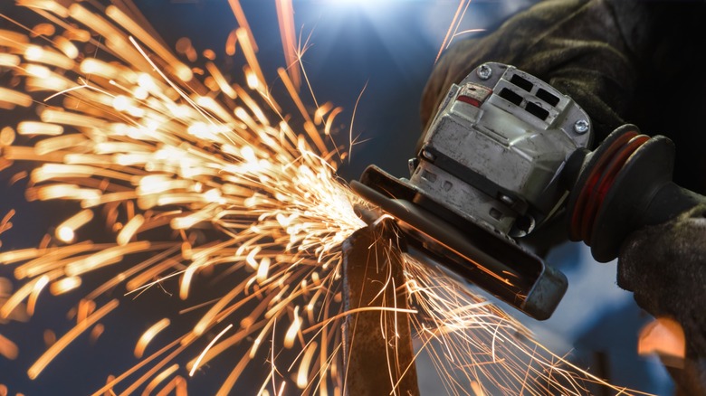 An angle grinder in action on a piece of metal